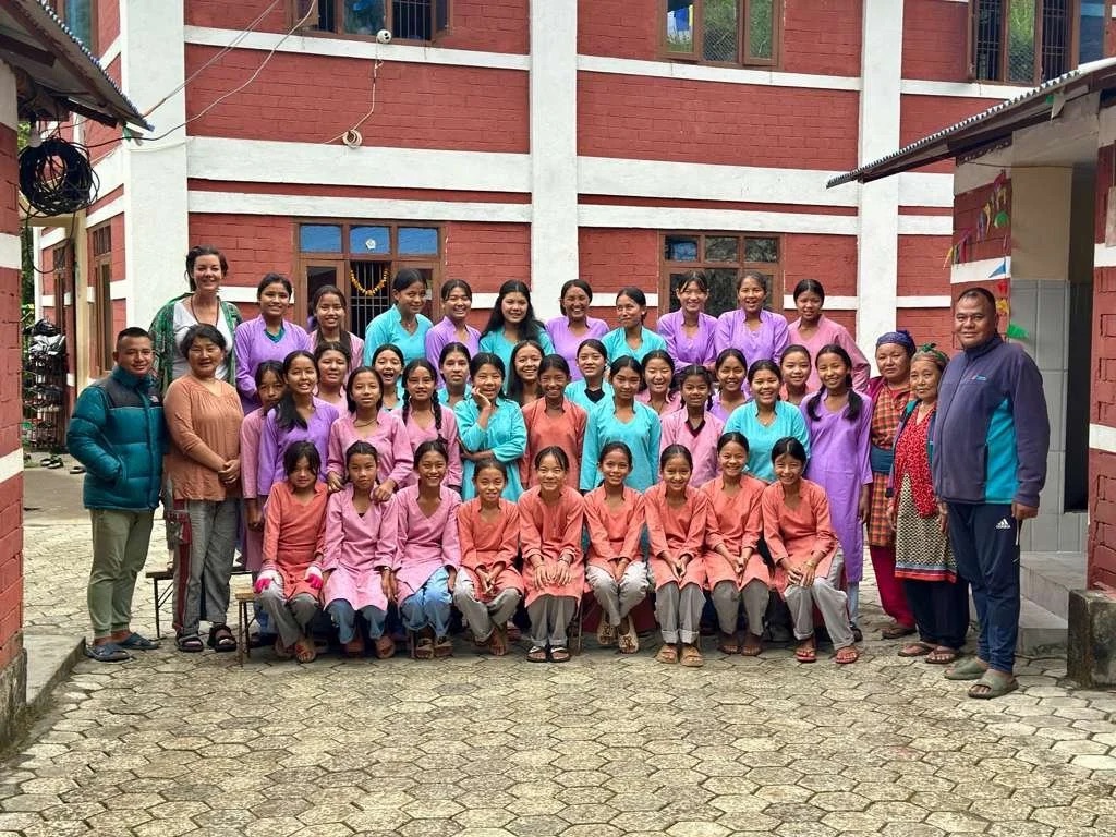 Girls and staff of the INpowerment Home gathered outside the school