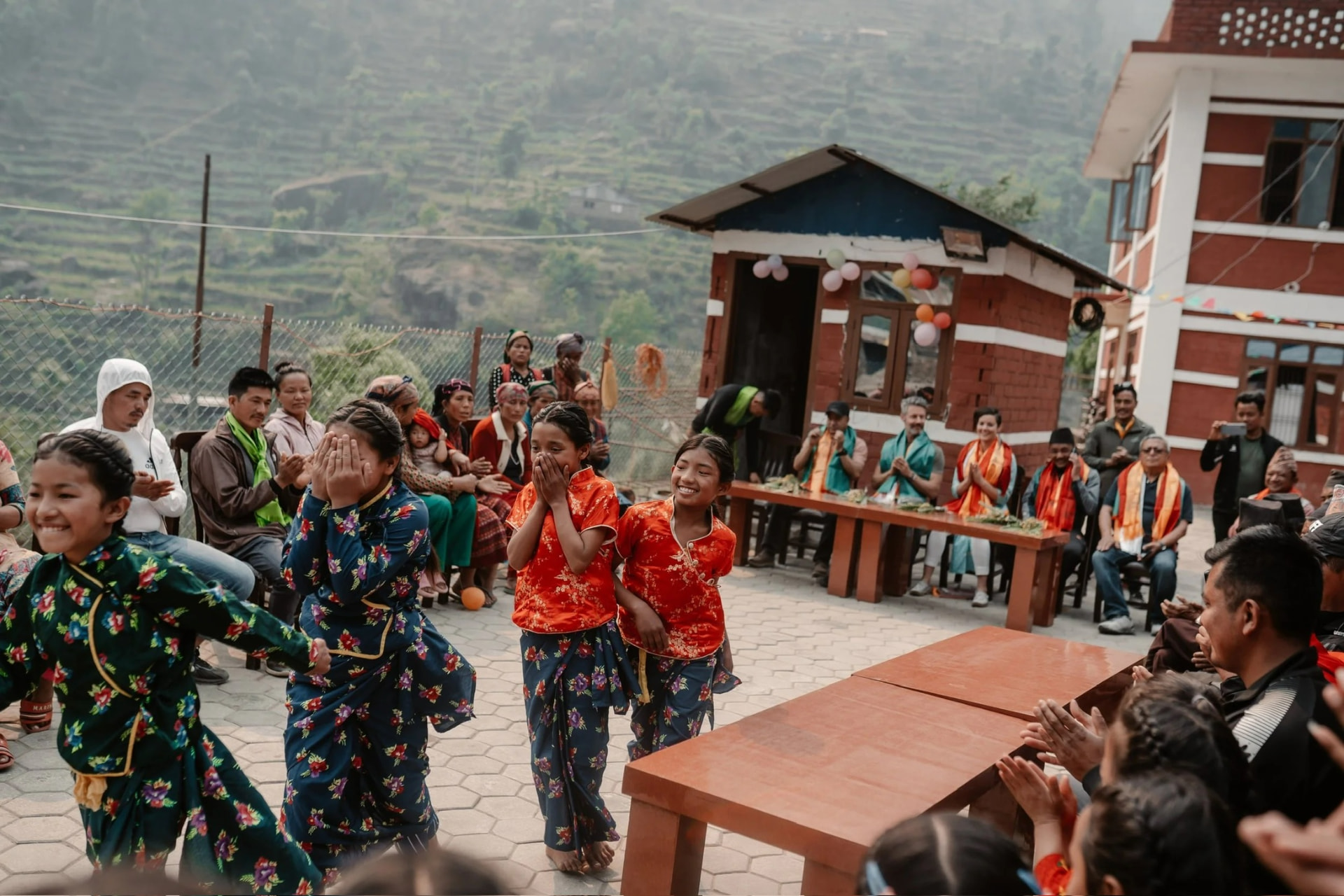 Girls in traditional dress dancing for the community in Ghyangphedi